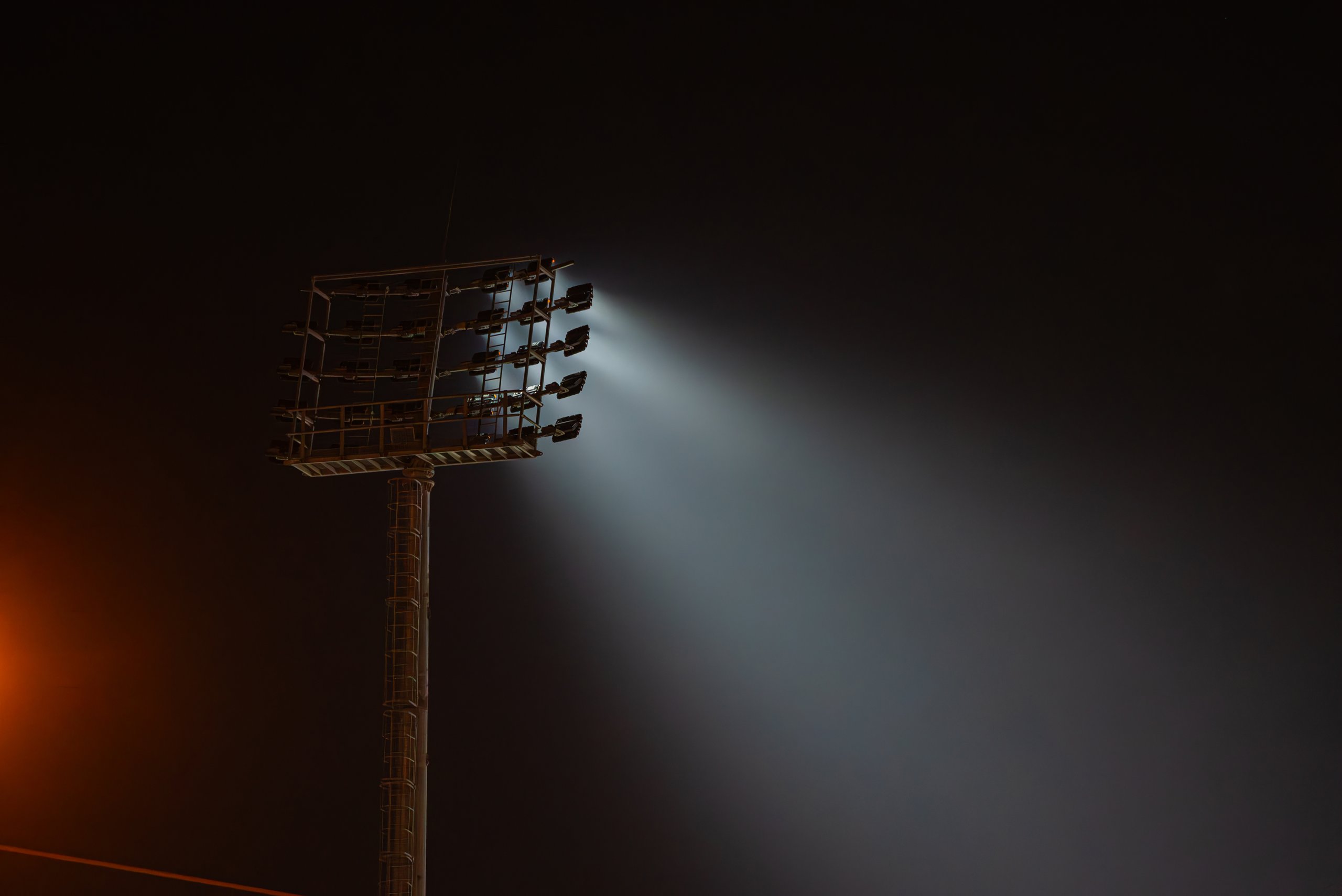 Powerful stadium lights beaming brightly at night
